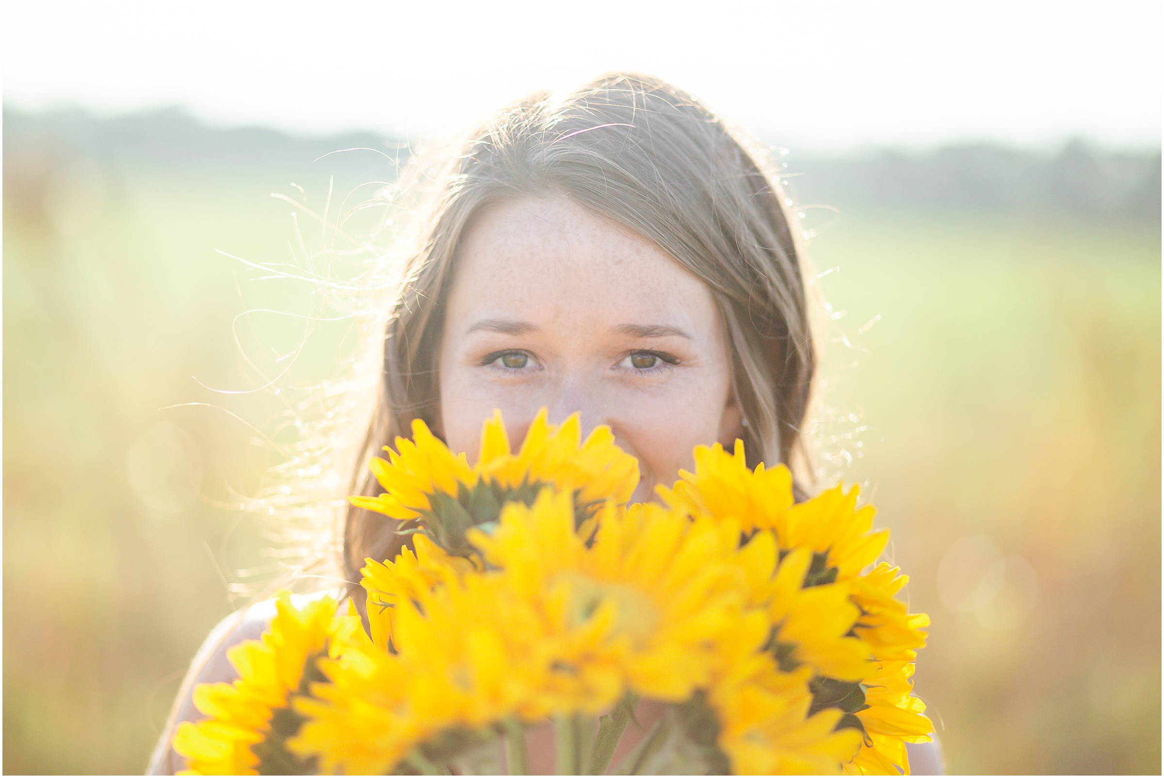 2019 Hardee High School Senior, Claire, poses in a golden grassy field in Wauchula FL at sunset.