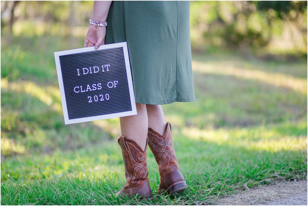 Class of 2020, the year of COVID-19 Quarantine, senior Stephanie poses for graduation, senior photos in an open field in Zolfo Springs, Florida.